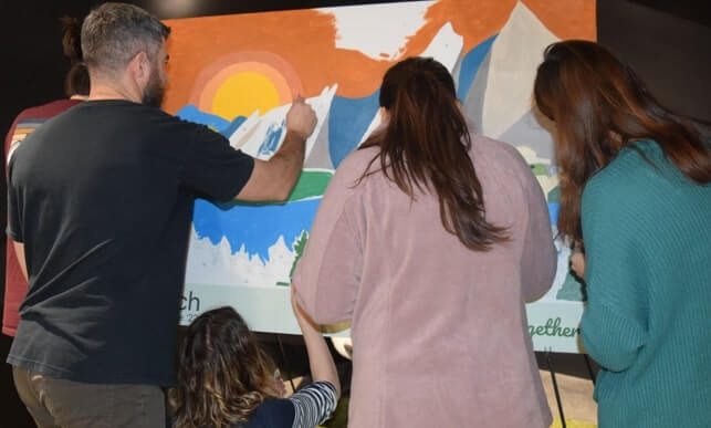 Large paint by number mural in progress at an event